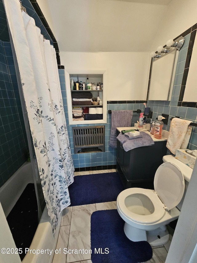 bathroom featuring tile walls, vaulted ceiling, shower / tub combo, toilet, and radiator heating unit