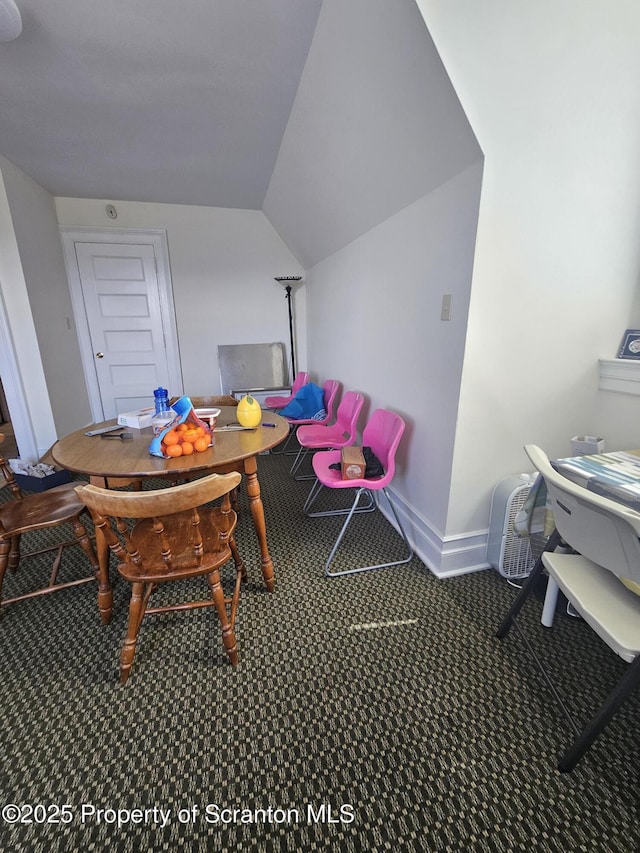 dining area with baseboards, carpet, and lofted ceiling