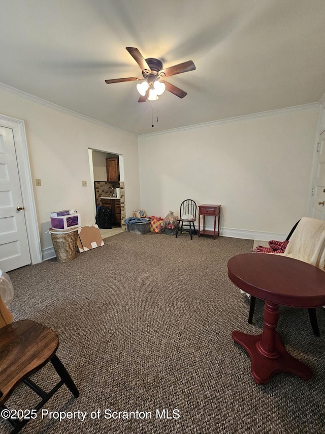 interior space featuring crown molding, carpet flooring, baseboards, and ceiling fan