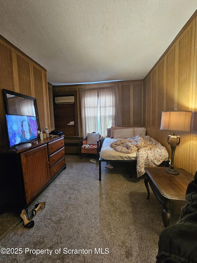 carpeted bedroom with a textured ceiling and a wall mounted air conditioner