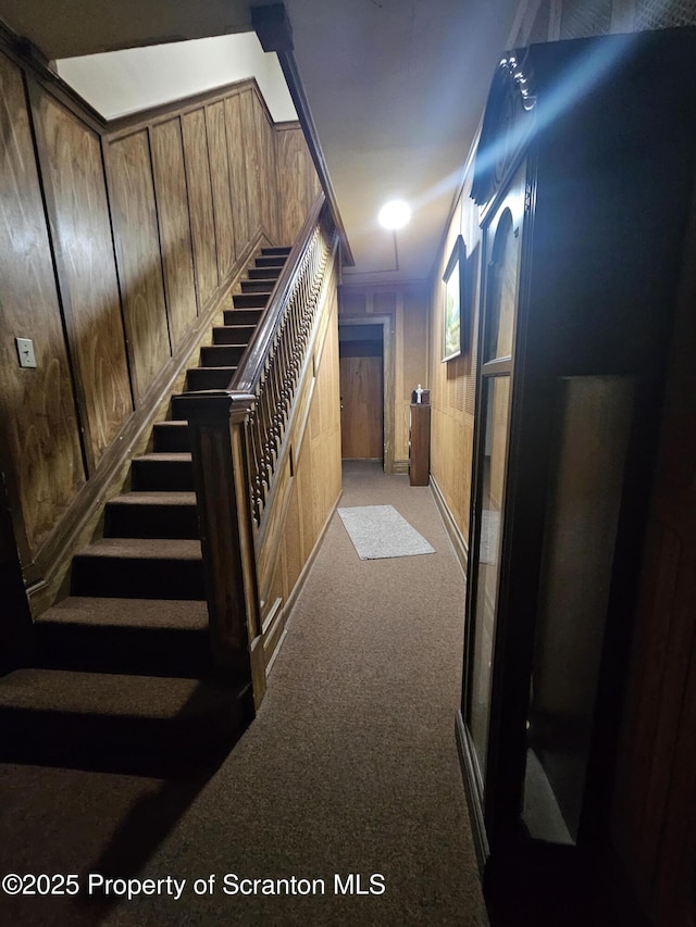 hallway featuring carpet and stairs