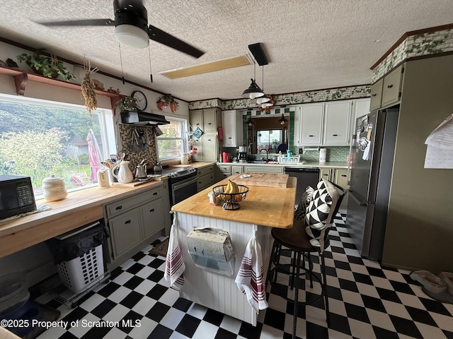 298 Crosstown Hwy, Union Dale, PA 18470 - kitchen featuring dark flooring, butcher block counters, black appliances, gray cabinets, and a textured ceiling