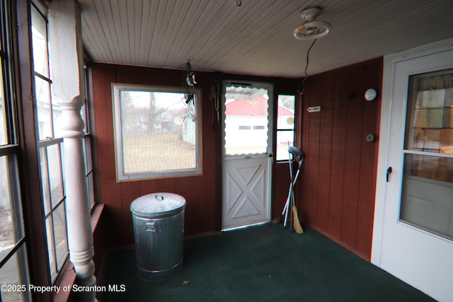 unfurnished sunroom with wood ceiling