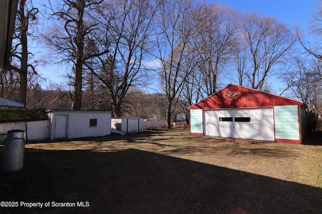 view of yard with a garage and a shed