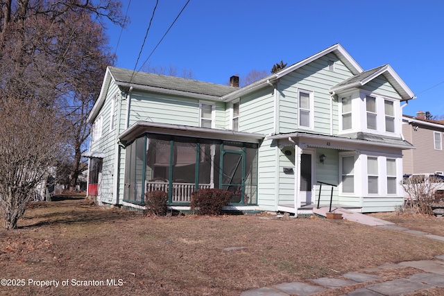 view of front of property with a sunroom