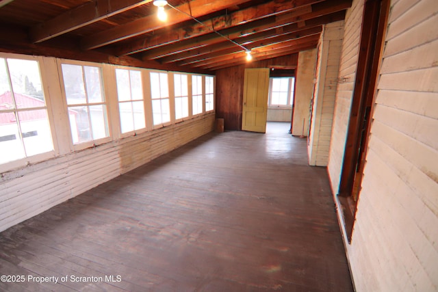 unfurnished sunroom with beamed ceiling