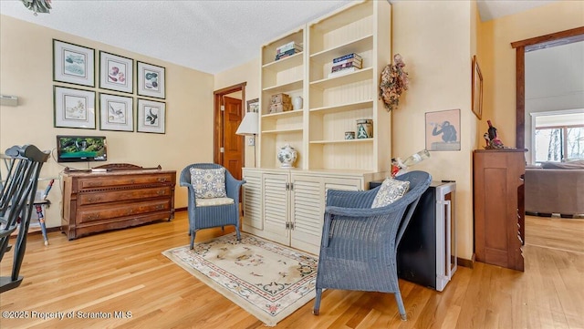 141 Cove Point Cir, Lakeville, PA 18438 - living area featuring wood finished floors and a textured ceiling
