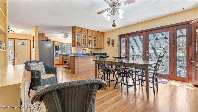 141 Cove Point Cir, Lakeville, PA 18438 - dining room with a ceiling fan, light wood-style flooring, and a textured ceiling