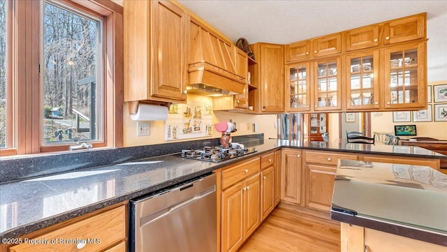 141 Cove Point Cir, Lakeville, PA 18438 - kitchen with dishwasher, black gas stovetop, light wood finished floors, glass insert cabinets, and dark stone counters