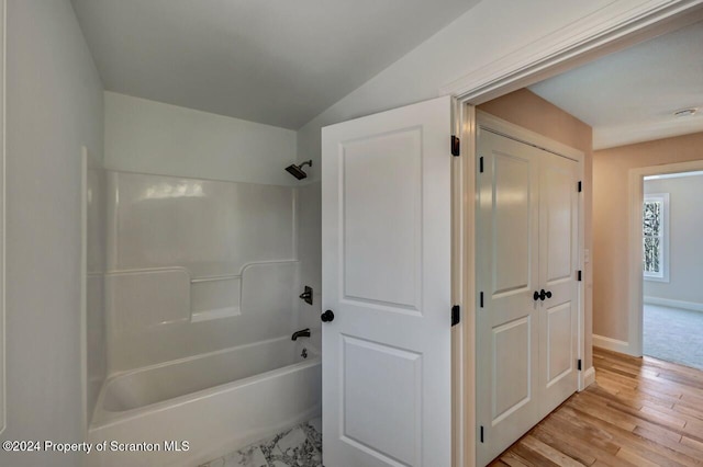 bathroom with wood-type flooring and shower / washtub combination