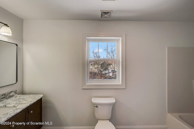 bathroom with visible vents, vanity, a bath, baseboards, and walk in shower