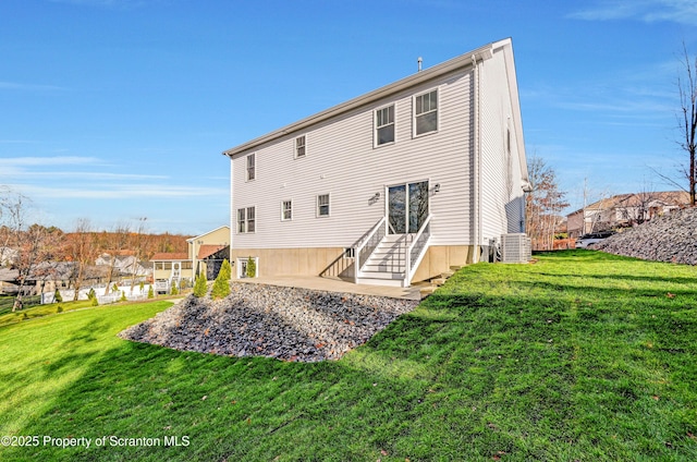 back of house with entry steps, central AC, and a lawn