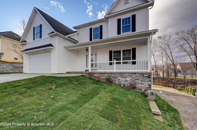 view of property featuring a front yard, a porch, and a garage