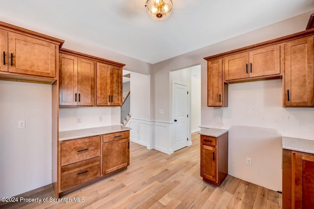 kitchen with light stone countertops and light hardwood / wood-style flooring