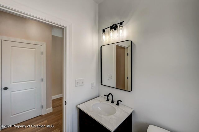 bathroom with vanity and hardwood / wood-style flooring