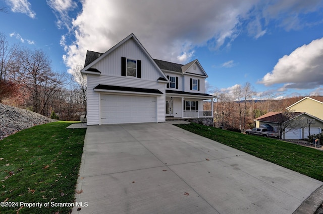 view of front of home featuring a porch, board and batten siding, a garage, driveway, and a front lawn