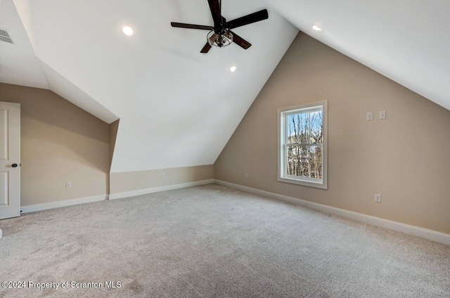 additional living space featuring ceiling fan, light colored carpet, and vaulted ceiling