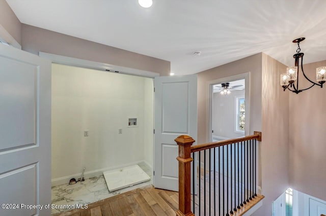 interior space featuring ceiling fan with notable chandelier