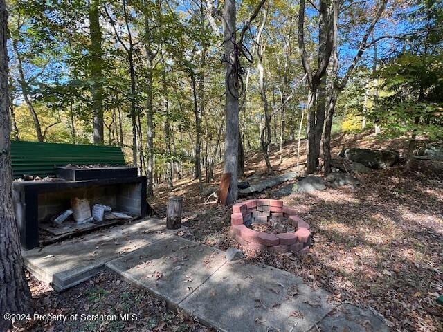 view of yard with an outdoor fire pit