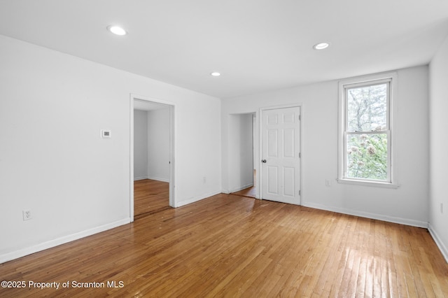 interior space with light wood-style floors, baseboards, and recessed lighting
