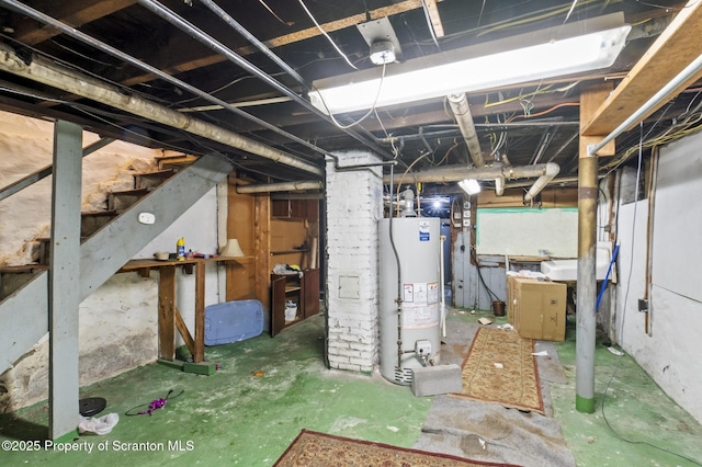 unfinished below grade area featuring stairway and water heater
