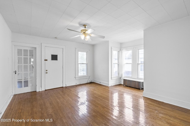 entrance foyer featuring baseboards, a ceiling fan, radiator heating unit, and hardwood / wood-style floors