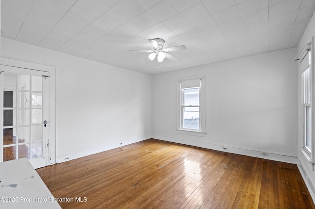 spare room featuring wood-type flooring and ceiling fan