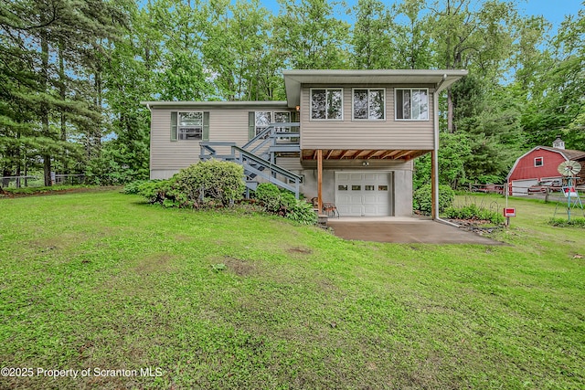 13 Hillside St Unit L 25, Nicholson, PA 18446 - view of front of home with stairway, a garage, driveway, and a wooden deck
