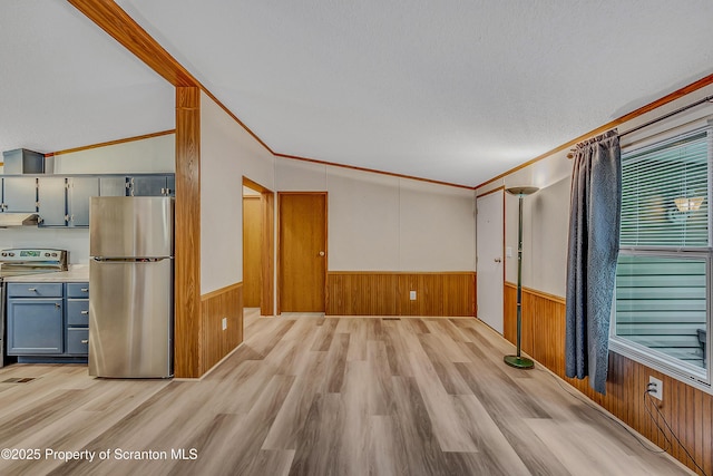 13 Hillside St Unit L 25, Nicholson, PA 18446 - unfurnished living room with wainscoting, wooden walls, light wood-style flooring, and ornamental molding