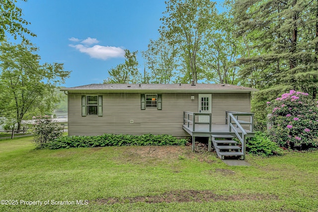 13 Hillside St Unit L 25, Nicholson, PA 18446 - rear view of house featuring a deck and a yard