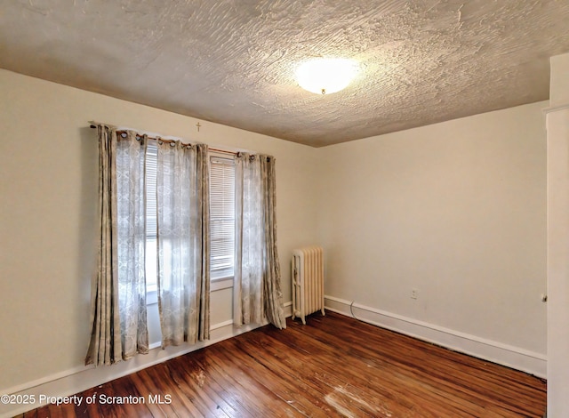 15 Leonard St, Wilkes-Barre, PA 18702 - empty room featuring radiator, hardwood / wood-style floors, and healthy amount of natural light
