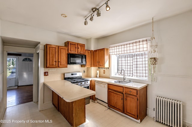 15 Leonard St, Wilkes-Barre, PA 18702 - kitchen with radiator, black microwave, stainless steel range with gas cooktop, a peninsula, and white dishwasher
