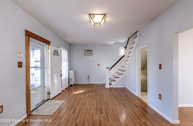 15 Leonard St, Wilkes-Barre, PA 18702 - foyer with radiator, stairway, light wood-type flooring, and plenty of natural light