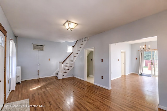 15 Leonard St, Wilkes-Barre, PA 18702 - entrance foyer featuring a chandelier, light wood finished floors, stairway, radiator heating unit, and a wall mounted AC
