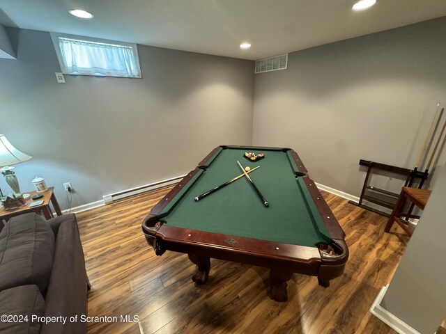 game room featuring dark hardwood / wood-style flooring, pool table, and a baseboard heating unit