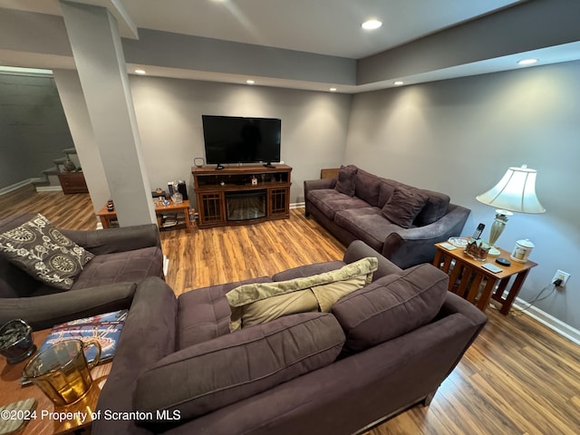 living room with wood-type flooring and a fireplace