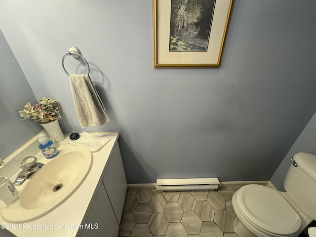 bathroom featuring toilet, vanity, and tile patterned floors