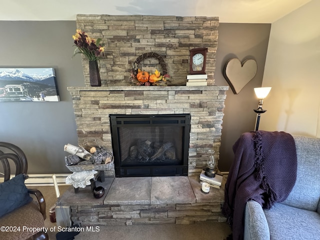 living room featuring baseboard heating and a fireplace