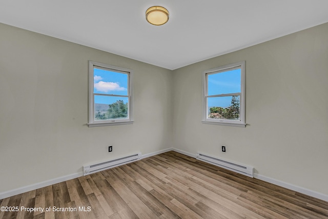 633 Connell St, Scranton, PA 18505 - unfurnished room featuring baseboard heating, plenty of natural light, and wood finished floors