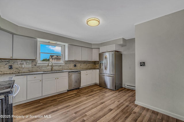633 Connell St, Scranton, PA 18505 - kitchen with stainless steel appliances, tasteful backsplash, light wood-style flooring, baseboard heating, and crown molding