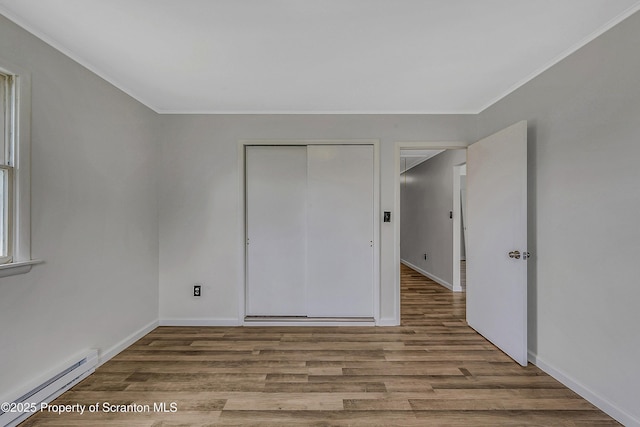 633 Connell St, Scranton, PA 18505 - unfurnished bedroom featuring a baseboard radiator, wood finished floors, ornamental molding, and a closet