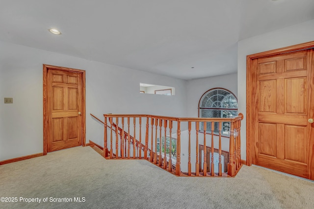 corridor featuring recessed lighting, carpet, an upstairs landing, and baseboards