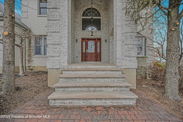 property entrance with brick siding