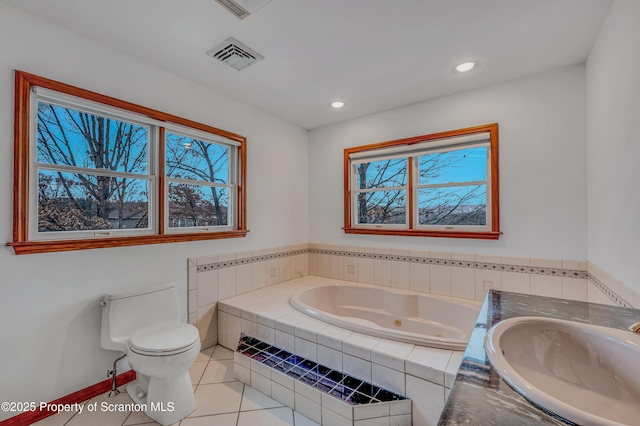 full bath featuring visible vents, toilet, a tub with jets, tile patterned floors, and a sink