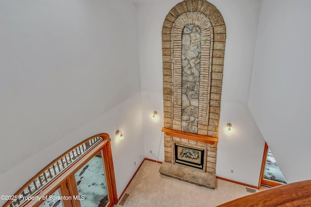 living room with carpet, a fireplace, and visible vents