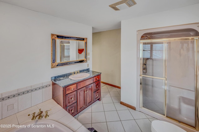 full bath with a stall shower, visible vents, toilet, tile patterned floors, and vanity