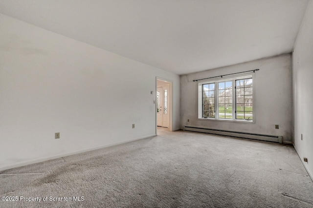 carpeted empty room with baseboards and a baseboard radiator
