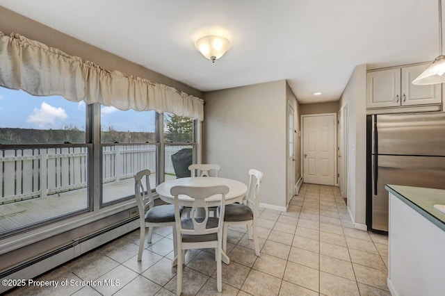 dining area with recessed lighting, a baseboard radiator, light tile patterned floors, a water view, and baseboards