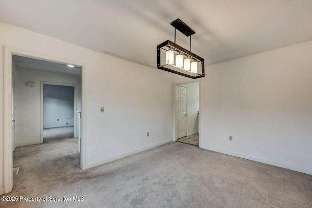 unfurnished dining area with baseboards and carpet flooring