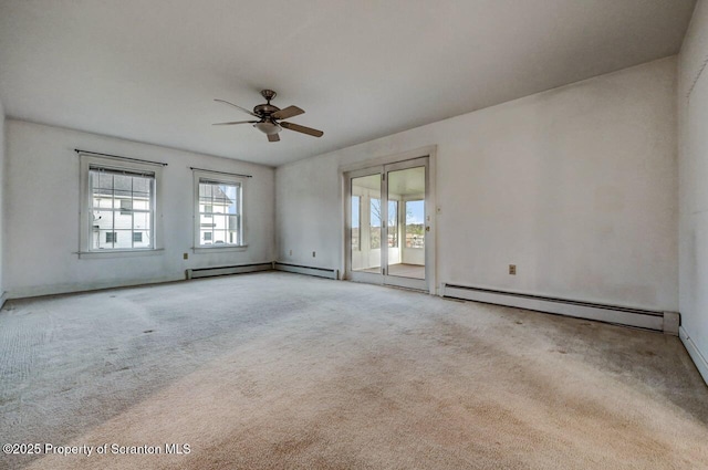 carpeted spare room with a ceiling fan, baseboards, and baseboard heating